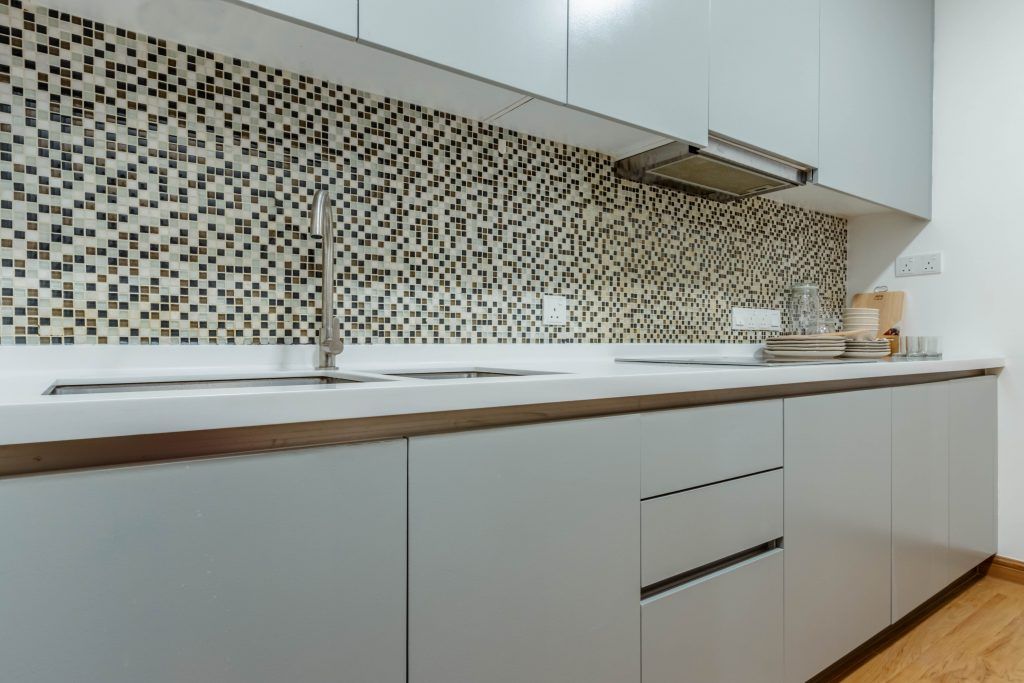Modern kitchen cabinet with mosaic tile backsplash